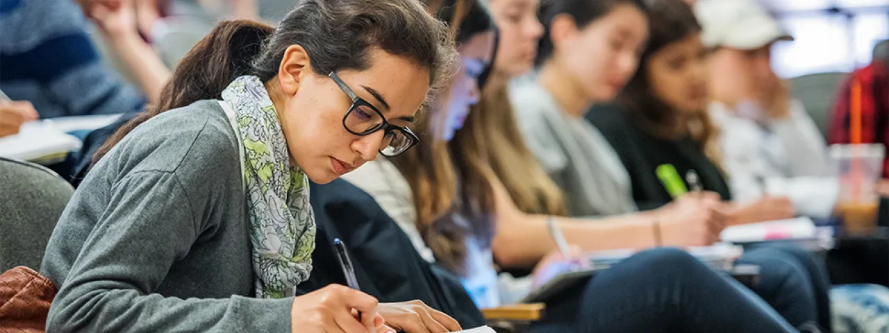 Students taking notes in economics class