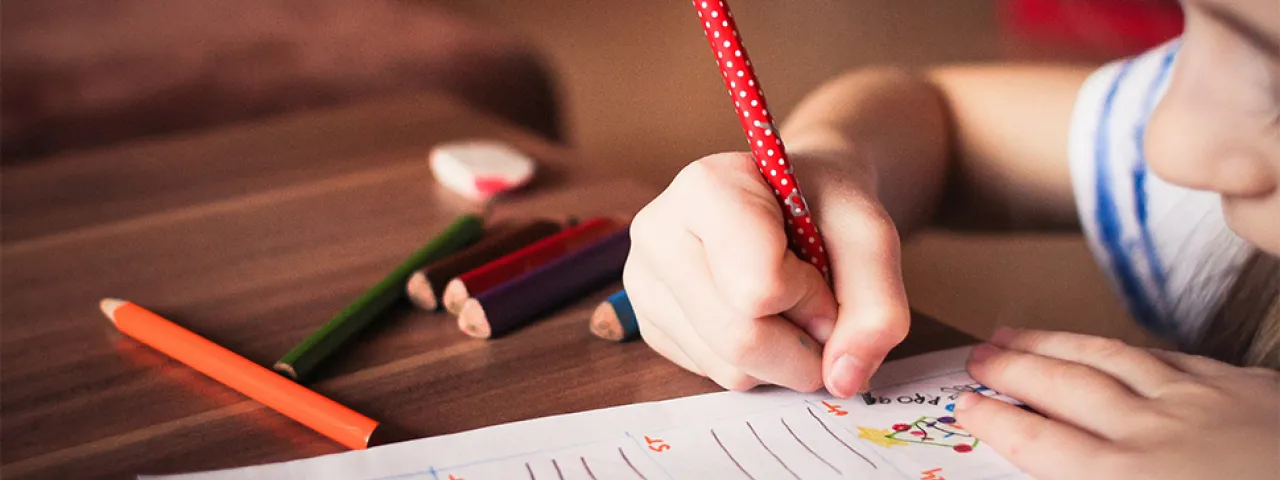 Child writing at a desk