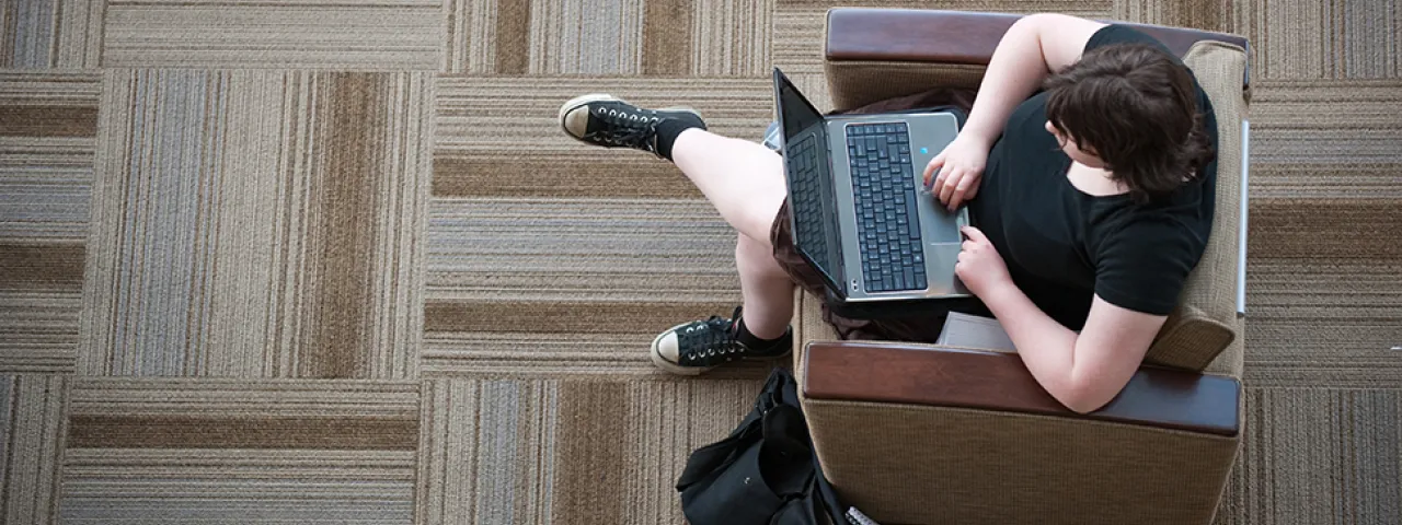 Student studying with laptop.