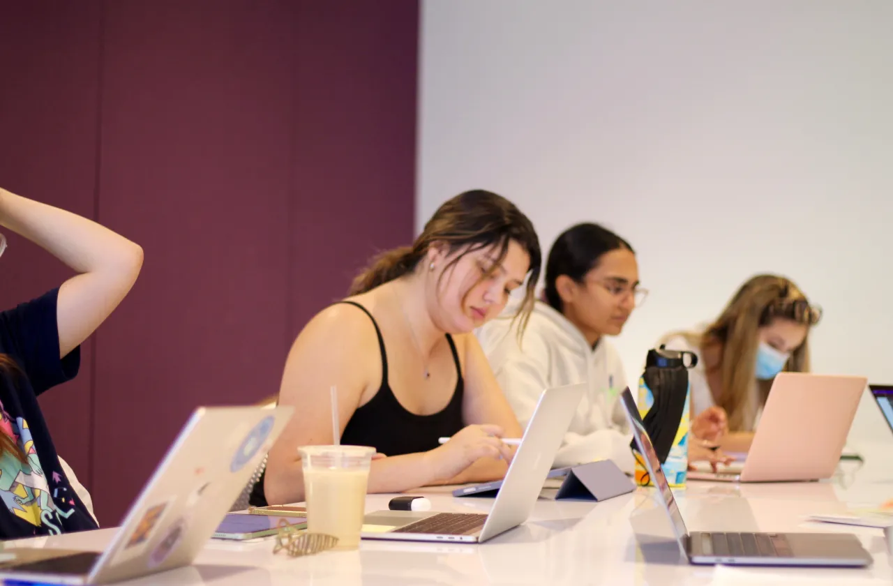 Students in a tutoring session, on their laptops.