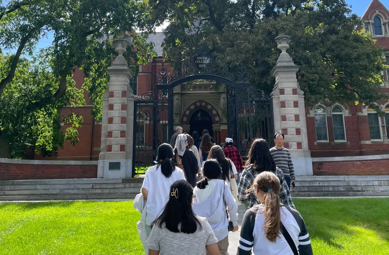 Students walking toward the Grecourt Gates.