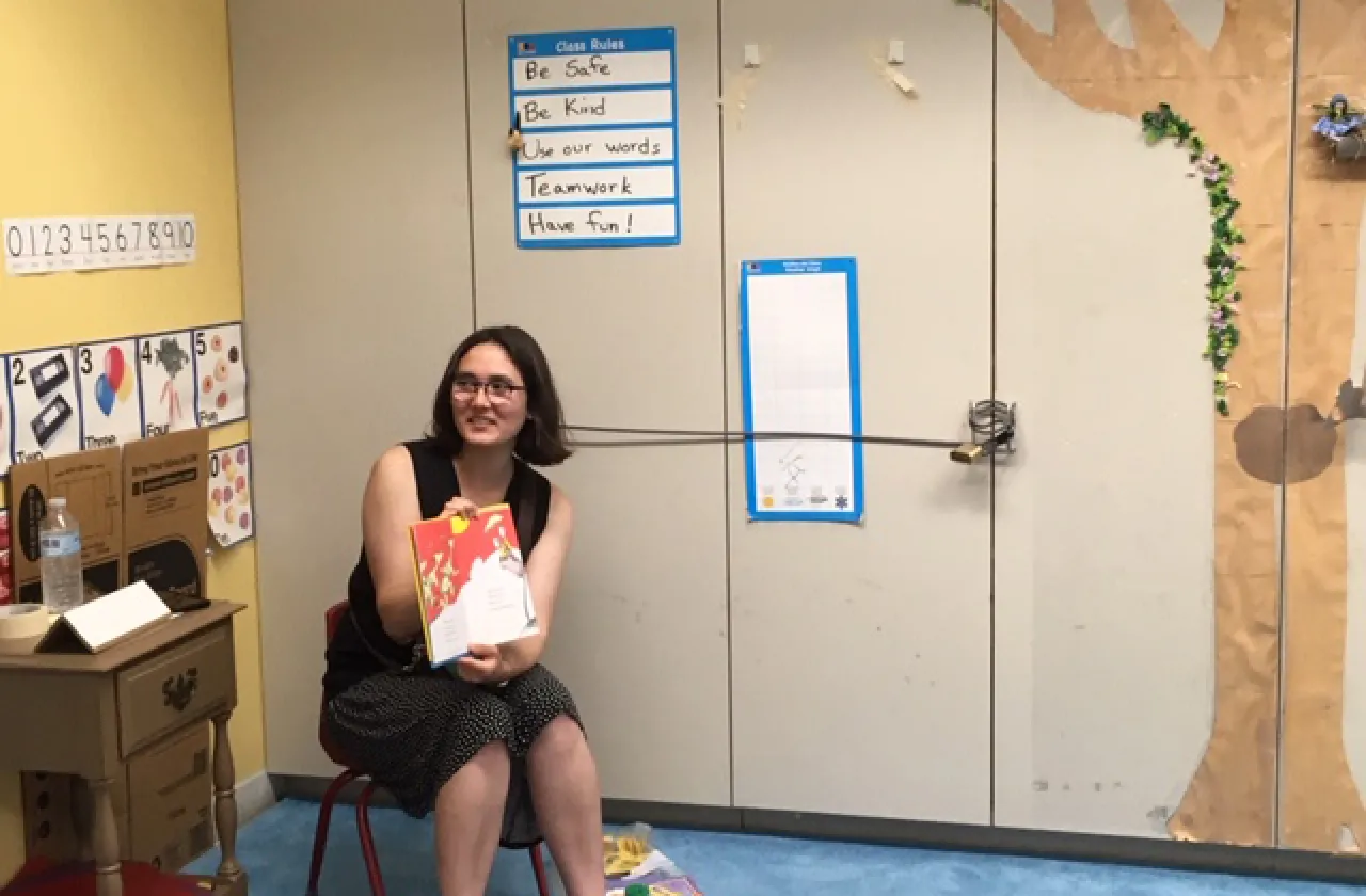 Tati Galli reading a book out-loud