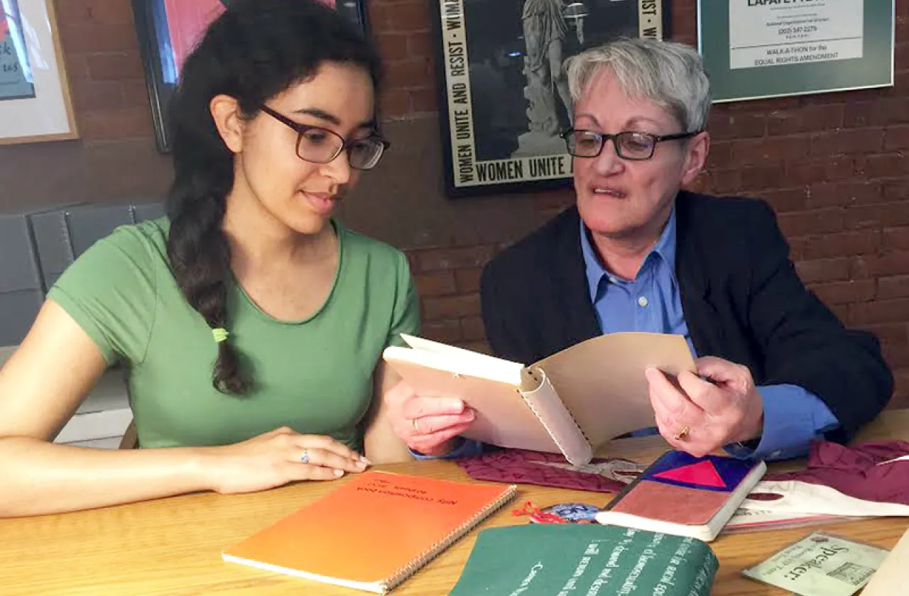 Alicia Bowling '17 (left) and activist Carmen Vazquez, who is featured in Smith's new MOOC, review materials Vazquez donated to Smith's Sophia Smith Collection.