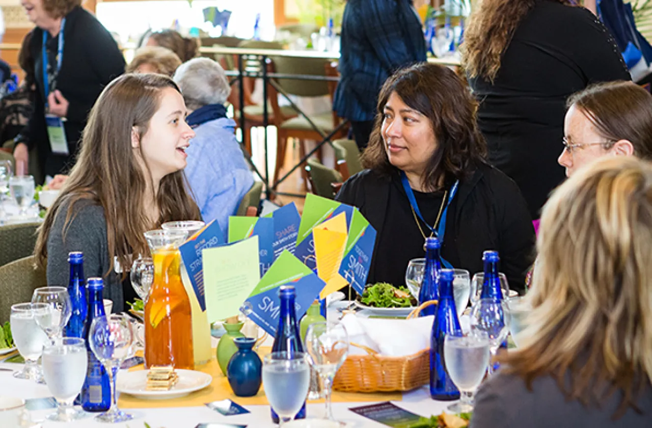 Alumnae volunteers sitting around a table