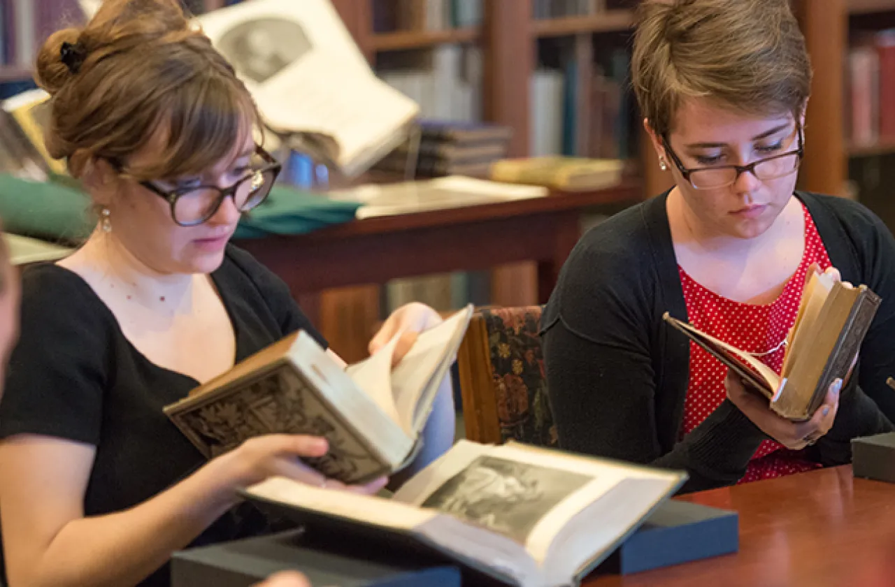 Students looking at books in the Mortimer Rare Book Room
