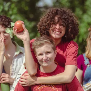 Two students picking apples.