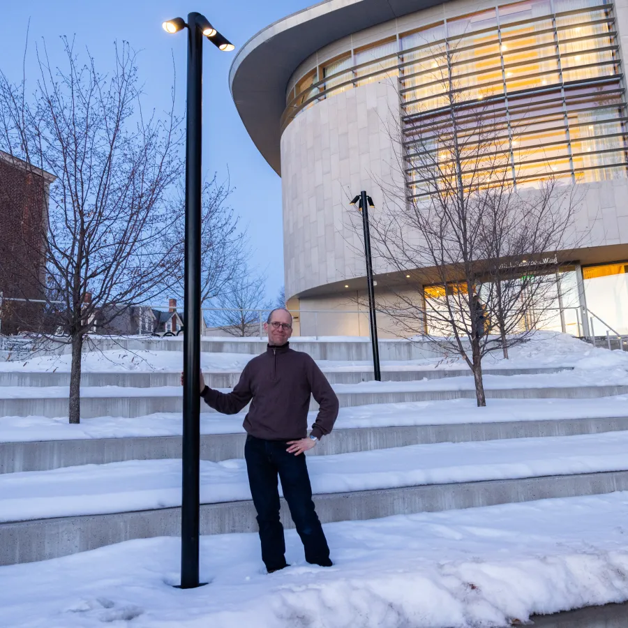 Professor James Lowenthal stands next to a night sky-friendly outdoor light behind the Smith library