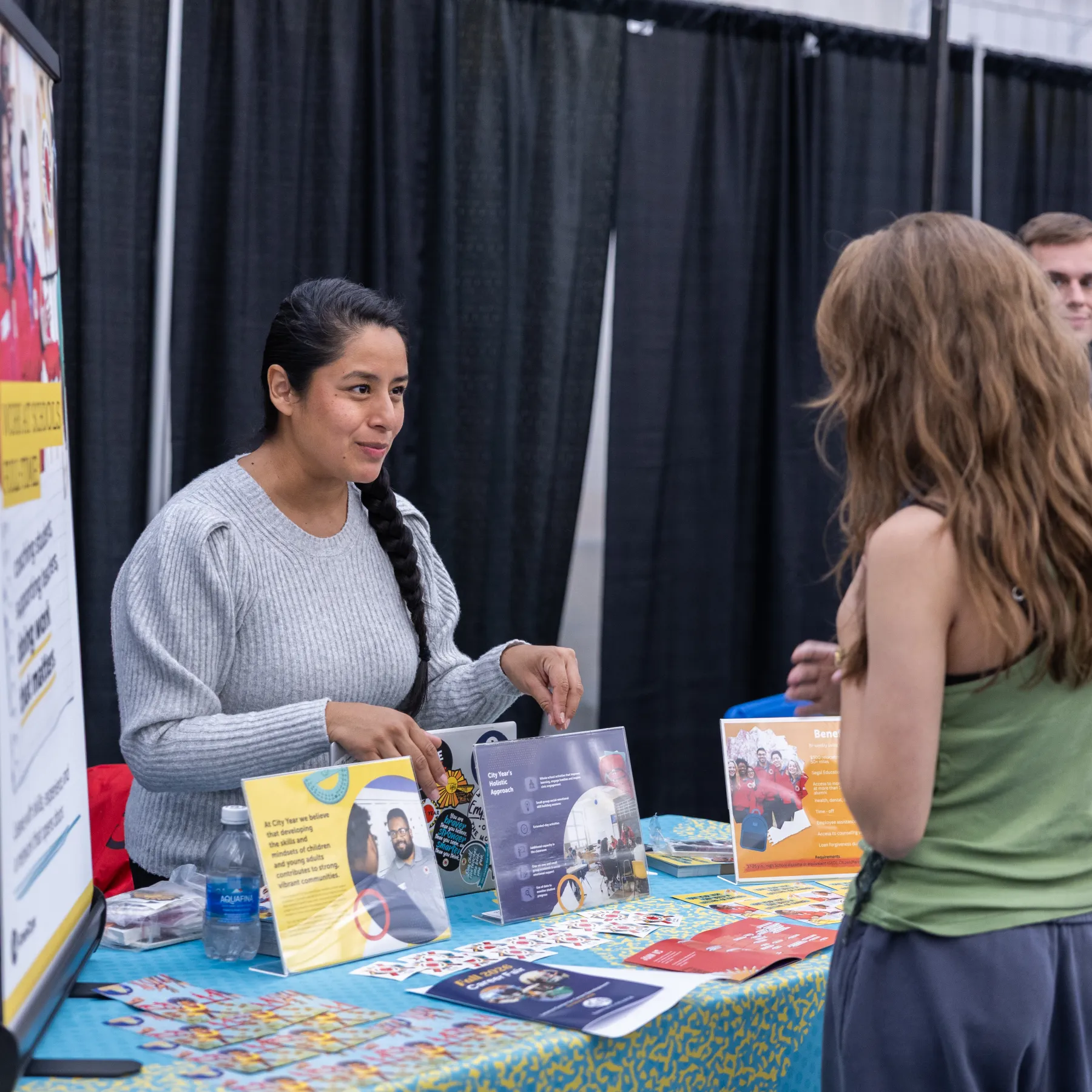 An employer interacting with a student at the Job & Internship Fair.