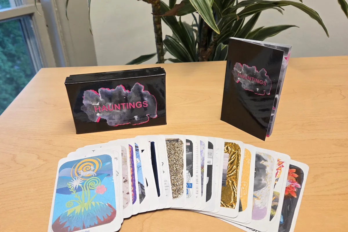 The tarot deck laid out on a table, with The Fool card on top of the pile.