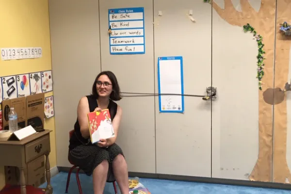 Tati Galli reading a book out-loud