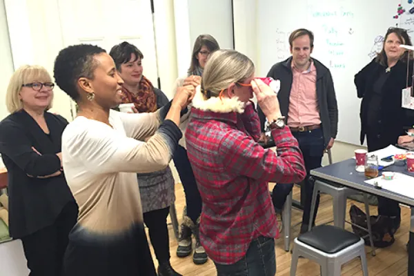 Digital scholarship librarian Miriam Neptune (front left) helps government professor Mlada Bukovansky put on goggles during a faculty workshop in the Design Thinking Initiative's new space in Capen Annex.