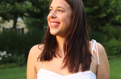 A student smiling outside.