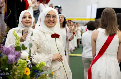 A student holding a rose during Ivy Day