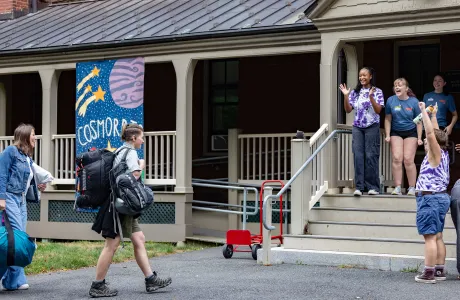 Housemates greet a new student at