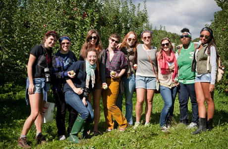 A group of Smithies smiling and posing together at an apple orchard.