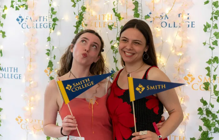 Students pose with pennants in the photo booth