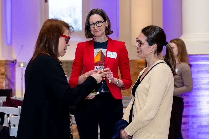 Three alums engaged in conversation.