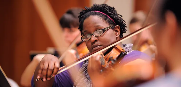 Orchestra student playing a violin