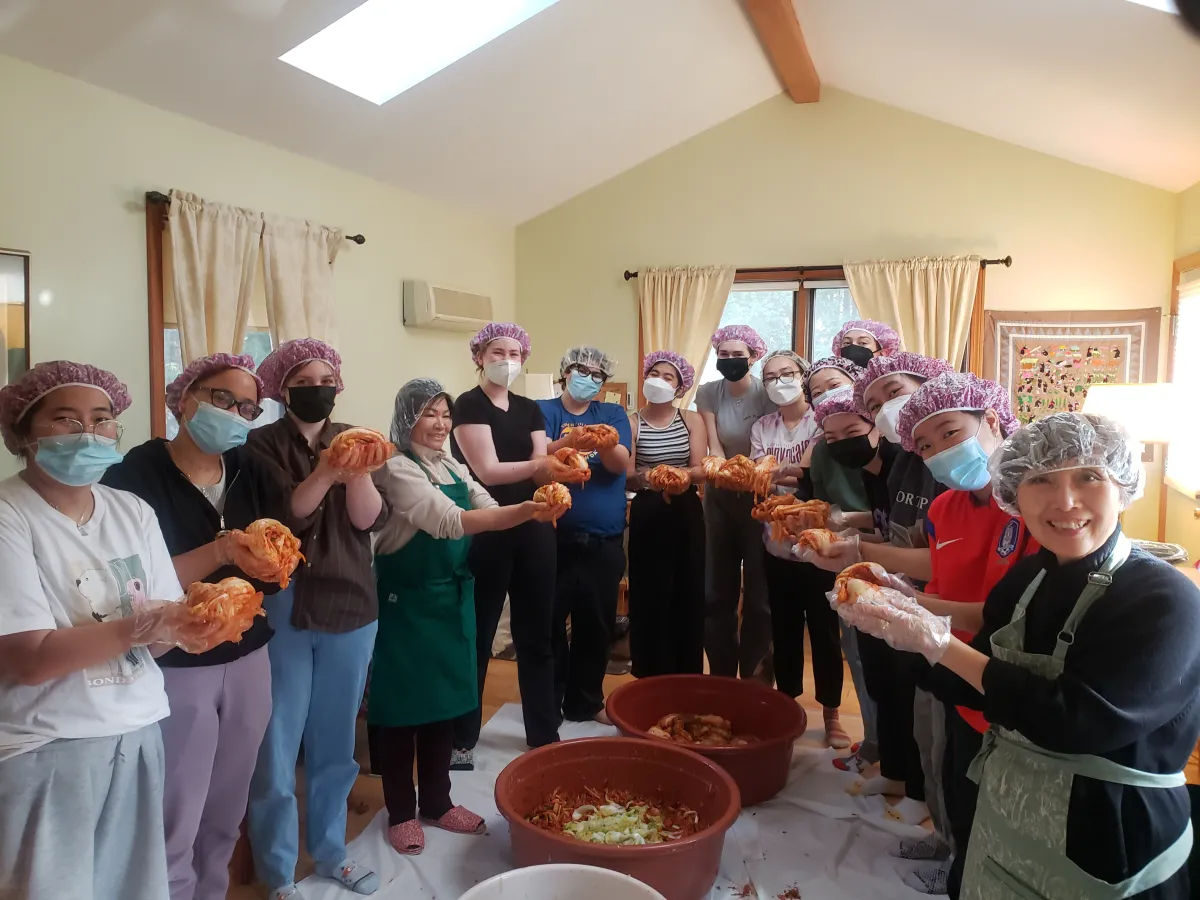 Students holding up finished kimchi