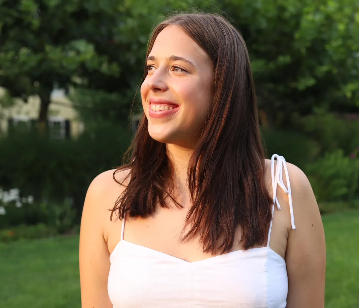 A student smiling outside.