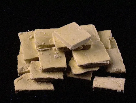A pile of broken, beige rectangular chunks appears crumbly and unevenly cut