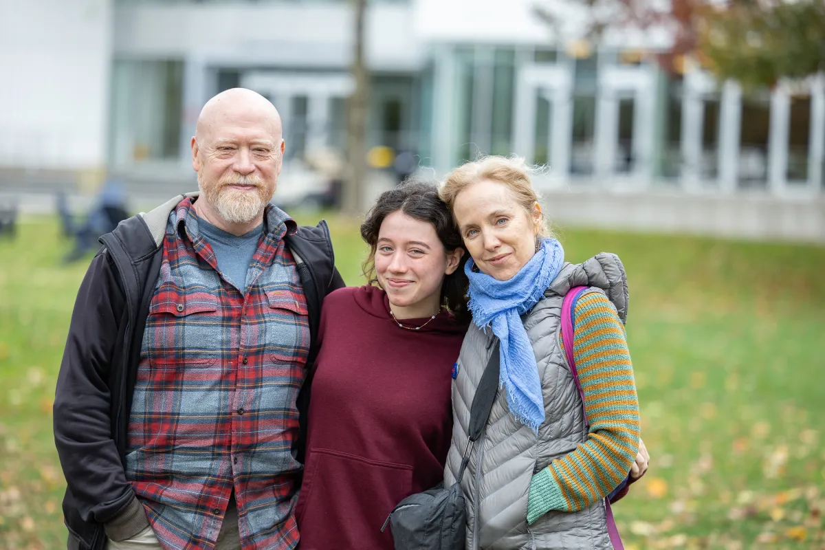 A Smithie poses with family on Chapin lawn during Family Weekend.