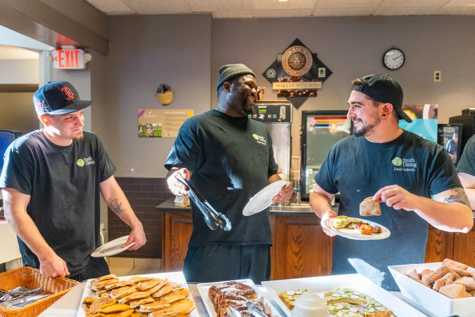 Smith staff laugh while in a line to try the new plant-based dishes