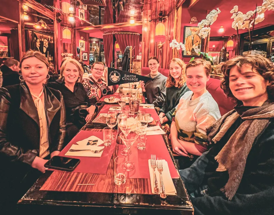 Students gathered around a table in Paris.
