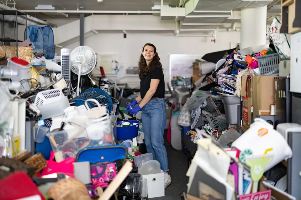 Molly Neu sorting through piles of donations at SmithCycle in Scales House basement