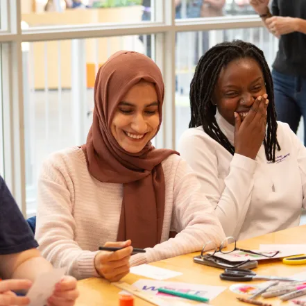 Two Smith students laugh during a workshop at ZineFest