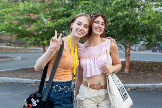 Two precollege students smiling.