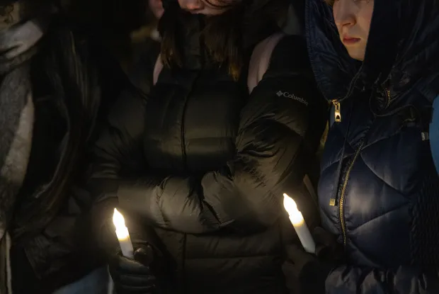 students holding LED candles