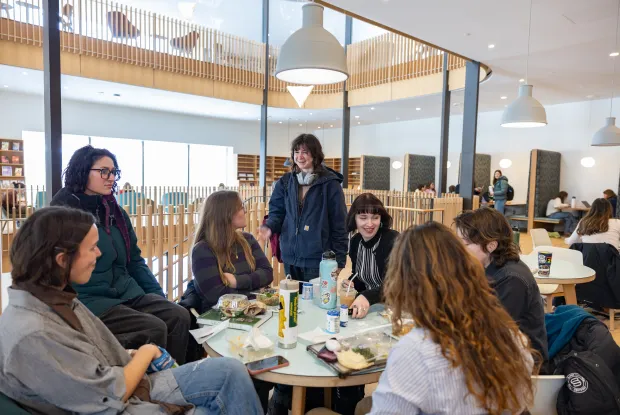 Students gathered around a crowded table in the Compass Café.